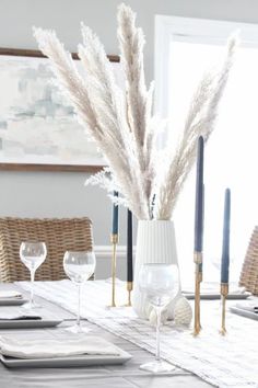 a dining room table set with place settings