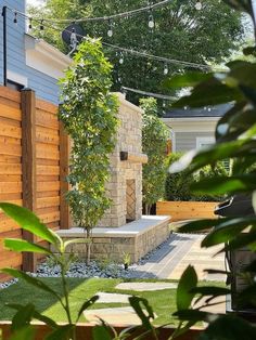 an outdoor area with wooden fence and stone bench