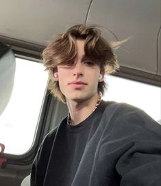 a young man sitting in the back seat of a car