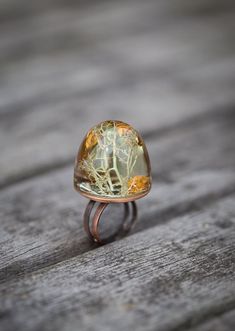 This unusual transparent nature inspired chunky dome statement ring is made from high quality eco resin. The ring contains sparkled imitation of dark gold flakes and natural moss that comes from the legendary enchanted forest of Brocéliande in Brittany (France), the territory of Merlin the Magician and the Knights of the Round Table. Adjustable antiqued brushed copper brass ring base (cadmium free, nickel free and lead free) My resin jewellery is cast in handmade by me silicone molds, hand sande Ooak Fairy, Cheap Engagement Rings, Eco Resin, Resin Ring, Gold Flakes, Dark Gold, Enchanted Forest, Flower Jewellery, Cocktail Ring