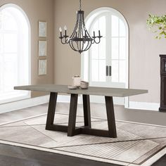 a dining room table with a chandelier hanging from it's centerpiece