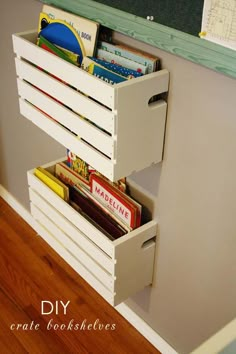 a white wooden crate with some books in it and a chalkboard on the wall