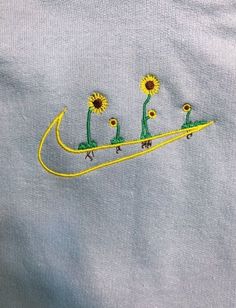 an embroidered t - shirt with sunflowers on it