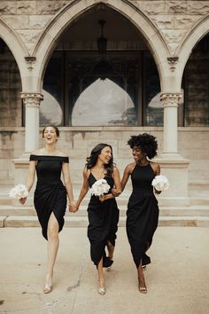 three women in black dresses are walking together