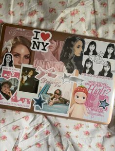 i love new york stickers on a bed with pink and white flowers in the background