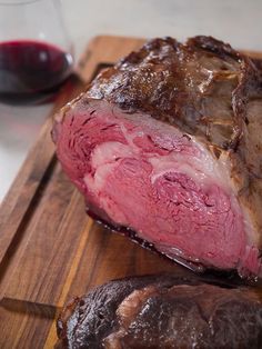 a piece of meat sitting on top of a wooden cutting board