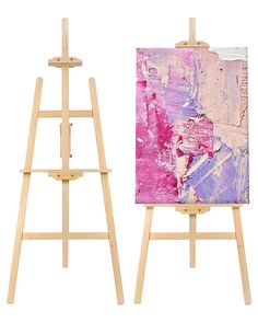 two wooden easels with paintings on them, one is pink and the other is blue