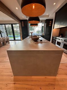 an island in the middle of a large kitchen