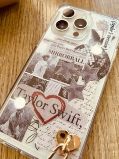 a cell phone case with an image of a heart and two keys attached to it