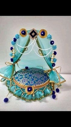 an elaborately designed bed with blue and gold decorations