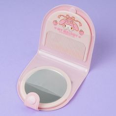 a pink toy with a mirror on top of it