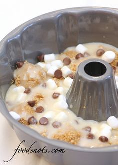 a cake pan filled with pudding and marshmallows