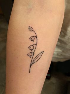 a small flower tattoo on the leg