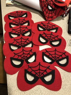 several red and black masks on a table