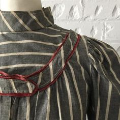 Item Details.This is divine! Bought in a specialist costume market in the South of France, an original Edwardian high neck bodice dating from around 1910. Beautifully made in a slate grey and cream striped cotton with ruby red silk satin trim around the shoulders. It also features lovely pleat and pin tuck details. Fully lined in lovely check fabrics, it is finished with original pearl buttons which are hidden when the outer layer front placket is fastened. Measurements: Bust: 34" (86 cm) Waist: Luxury Blouse With Striped Collar For Daywear, Luxury Pinstripe Top With Button Cuffs, Edwardian Blouse, Stripe Blouse, French Stripes, The White Stripes, The South Of France, Historical Costume, Dress Measurements