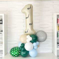 balloons are arranged in the shape of a giraffe on top of a shelf