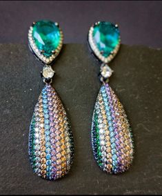 Sparkling Visual Flaunt your special occasion outfits with this contemporary large tear drop earrings in pave setting with micro multi colored cubic zircons These would make a perfect versatile gift Length: 2.25 Inches Shipping is free for orders $30 and above. Cheap Multicolor Teardrop Earrings, Pear-shaped Cubic Zirconia Party Earrings, Teardrop Pendant Earrings With Sparkling Stones For Party, Pear-shaped Cubic Zirconia Teardrop Earrings For Party, Multicolor Teardrop Earrings For Formal Occasions, Teardrop Earrings For Party, Teardrop Crystal Earrings For Party, Party Teardrop Pendant Earrings For Pierced Ears, Teardrop Earrings For Pierced Ears Party