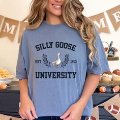 Comfort Colors Silly Goose Shirt, Retro Silly Goose University Tshirt, Funny Western Tee, Vintage Farm Graphic Tee, 90s Aesthetic Shirt   👕 *We use Comfort Colors® branded shirts. 📏 + The shirts are unisex and designed to be comfortable and flattering for both men and women. They may fit slightly large for women, so please check the sizing chart to find your ideal size. For a regular fit, order your usual size, or size down for a more fitted look. Keep in mind that unisex shirts are typically longer than women's shirts. 🌿 + MATERIAL: 100% Cotton Imported 🌍 Pull-on closure 🚪 Machine washable 🧼 Soft-washed, garment-dyed fabric 🧵 Double-needle collar 🧶 Twill-taped neck and shoulders 👕 Double-needle stitching on sleeves and hem ✂️ We recommend washing these garments in cold water with Silly Goose University, Western Tee, University Tshirt, Aesthetic Shirt, Silly Goose, Tshirt Funny, 90s Aesthetic, Vintage Farm, Aesthetic Shirts