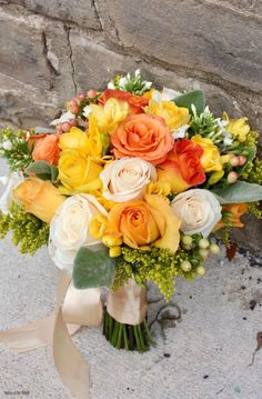 an orange and yellow bouquet is shown on the instagram