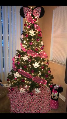 a christmas tree decorated with minnie mouse decorations