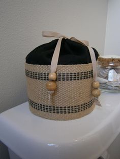 a basket sitting on top of a white toilet