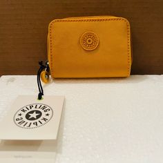 Kipling Women's Tops Wallets Color Spicy Gold. About This Item All-Round Zip And Snap Closure 2 Compartments For Coins 2 Compartments For Bills 4 Card Slots 1 Transparent Card Slot Trendy Yellow Wallet For Everyday Use, Trendy Yellow Wallets For Everyday Use, Yellow Coin Purse For Everyday Use, Casual Coin Purse With Interior Card Slots As Gift, Yellow Casual Wallet For Everyday Use, Casual Bifold Travel Coin Purse, Casual Coin Purse With Interior Card Slots, Yellow Wallet For Everyday Use, Casual Wallet For Gift