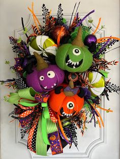 a halloween wreath with pumpkins and witches