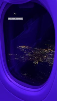 the view from inside an airplane window at night, looking out on the city lights