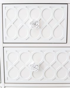 two white drawers with flowers on them