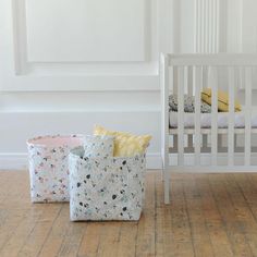 two baby cribs sitting next to each other in a room with white walls