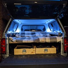 the back end of a pickup truck with its trunk open and mattress in the bed