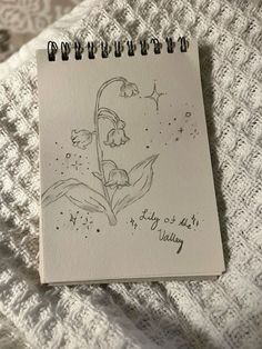 a notebook with a drawing of a woman's face on it