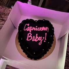 a heart shaped cake with the words capriccion baby written on it in a box