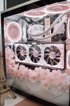 the inside of a computer case with pink flowers in front of it and an eiffel tower