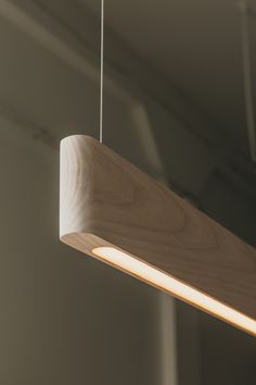 a wooden light fixture hanging from a ceiling