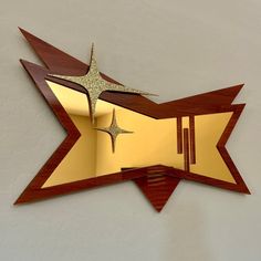 a star shaped mirror hanging on the side of a wall