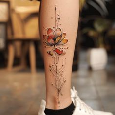 a woman's leg with a flower tattoo on it