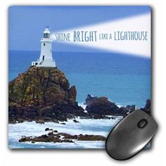 a computer mouse pad with a lighthouse on it and the words shine bright like a lighthouse