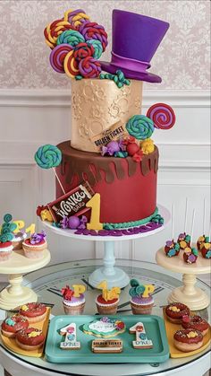 a table topped with lots of cakes and cupcakes