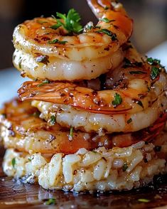 there is a stack of shrimp on top of rice