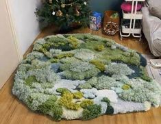 a living room with a rug on the floor and a christmas tree in the corner