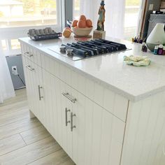 a kitchen with an island and stove top