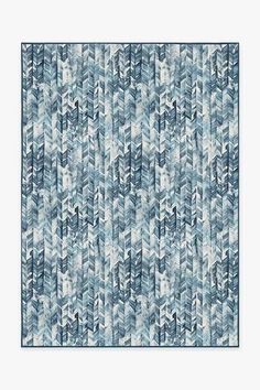 a blue and white rug with an abstract design