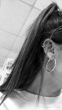 black and white photograph of woman with ear piercings