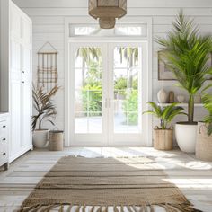 a living room with white walls and flooring, potted plants on either side of the window