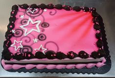 a pink and black cake with stars on it