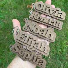 three wooden keychains with words on them