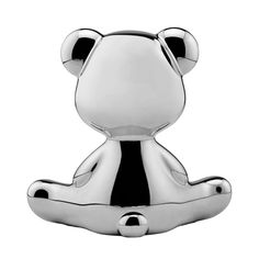 a silver teddy bear sitting on top of a white surface