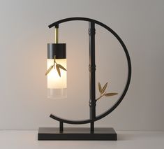 a lamp that is sitting on top of a wooden stand with a light bulb in the middle