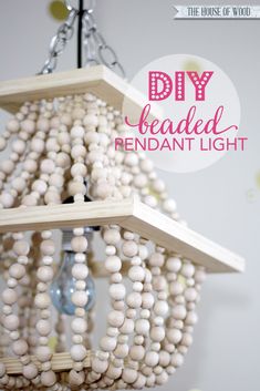 a bird feeder made out of beads and wood with the words diy beaded pendant light above it